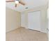 Bedroom featuring tile floors, a ceiling fan, and a double-door closet at 408 Valencia Park Dr, Seffner, FL 33584