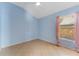Bedroom with light blue walls, tile flooring, and large window at 408 Valencia Park Dr, Seffner, FL 33584