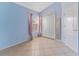 Bedroom with light blue walls, tile flooring, and a double-door closet at 408 Valencia Park Dr, Seffner, FL 33584