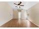 Large bedroom with wood laminate floors, neutral paint, a ceiling fan, and an ensuite bathroom at 408 Valencia Park Dr, Seffner, FL 33584