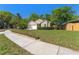 Inviting single-story home with lush front lawn, mature trees and attached two-car garage at 408 Valencia Park Dr, Seffner, FL 33584