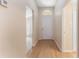 Bright hallway with laminate flooring, white trim, and access to multiple rooms at 408 Valencia Park Dr, Seffner, FL 33584