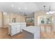 Spacious kitchen with a breakfast bar, neutral paint, modern lighting, and open layout with wood laminate flooring at 408 Valencia Park Dr, Seffner, FL 33584