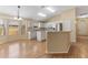 Bright eat-in kitchen with white cabinets, stainless appliances, modern lighting, and laminate floors at 408 Valencia Park Dr, Seffner, FL 33584