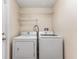 A laundry room with a washer, dryer, and shelving at 408 Valencia Park Dr, Seffner, FL 33584