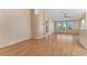 Open-concept living room with laminate flooring, neutral walls, and large windows at 408 Valencia Park Dr, Seffner, FL 33584