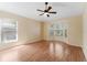 Spacious room with a bay window, ceiling fan, laminate floors, and light-colored walls creates a tranquil atmosphere at 408 Valencia Park Dr, Seffner, FL 33584