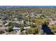 This aerial shot showcases the tranquil neighborhood with tree-lined streets and residences near a calm body of water at 419 Richards Ave, Clearwater, FL 33755