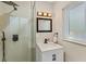 Well-lit bathroom with a glass enclosed shower and a single sink vanity with a white countertop at 419 Richards Ave, Clearwater, FL 33755