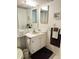 Traditional bathroom with green sink, white cabinets, and wall-mounted mirrors at 4525 Cove Cir # 304, St Petersburg, FL 33708