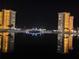 Night shot featuring water view of two buildings and bridge, with reflections in the water at 4525 Cove Cir # 304, St Petersburg, FL 33708