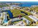 Aerial view of condo community highlighting waterfront location, community pool, and nearby amenities at 455 Alt 19 S # 162, Palm Harbor, FL 34683