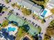 Aerial view of community pool, tennis courts, and condo buildings at 455 Alt 19 S # 162, Palm Harbor, FL 34683