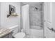 Clean bathroom featuring a shower over tub with white marble-look tile, white shower curtain and floating shelf at 455 Alt 19 S # 162, Palm Harbor, FL 34683