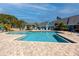 Community pool with lounge chairs and umbrellas offering a relaxing outdoor space for residents to enjoy at 455 Alt 19 S # 162, Palm Harbor, FL 34683