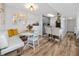 Bright dining area features a white table with a banquette, open to kitchen, and decorated with modern accents at 455 Alt 19 S # 162, Palm Harbor, FL 34683