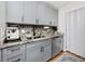 Modern kitchen with gray cabinets, stainless steel appliances, granite counters, and updated fixtures for stylish cooking at 455 Alt 19 S # 162, Palm Harbor, FL 34683