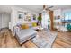 Bright living room featuring a comfortable sofa, wood flooring, and natural light at 455 Alt 19 S # 162, Palm Harbor, FL 34683