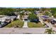 Aerial shot of the blue home, nestled among neighboring houses and lush greenery at 4716 Town N Country Blvd, Tampa, FL 33615