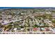 Community aerial showcasing homes, streets, and lush trees in a sunny neighborhood at 4716 Town N Country Blvd, Tampa, FL 33615