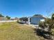 Exterior shot of sunroom and home with partially fenced backyard at 4716 Town N Country Blvd, Tampa, FL 33615