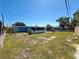 Aerial view of backyard with partially fenced yard and trees at 4716 Town N Country Blvd, Tampa, FL 33615