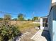 View of the backyard with a partial fence and sunroom addition at 4716 Town N Country Blvd, Tampa, FL 33615