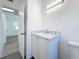 Bright bathroom features a single vanity with a marble-look countertop and ample storage at 4716 Town N Country Blvd, Tampa, FL 33615