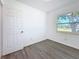 This bright bedroom has a view out the window and new floors at 4716 Town N Country Blvd, Tampa, FL 33615