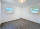 Minimalist bedroom with two windows, offering ample natural light and modern flooring at 4716 Town N Country Blvd, Tampa, FL 33615