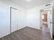 Clean bedroom featuring wood-look floors and access to an adjacent bathroom at 4716 Town N Country Blvd, Tampa, FL 33615