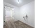 Hallway with laundry room and kitchen, providing seamless access and functionality at 4716 Town N Country Blvd, Tampa, FL 33615