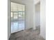 Hallway leading to a bright sunroom with tiled floors, enhancing the interior flow at 4716 Town N Country Blvd, Tampa, FL 33615