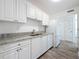 Remodeled kitchen with white cabinets, stone countertops, and stainless appliances at 4716 Town N Country Blvd, Tampa, FL 33615