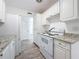 Bright kitchen featuring new white cabinets, stone counters, and modern appliances at 4716 Town N Country Blvd, Tampa, FL 33615