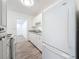 Bright, freshly remodeled kitchen with new white cabinets and stainless refrigerator at 4716 Town N Country Blvd, Tampa, FL 33615