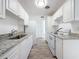 Modern kitchen featuring granite countertops, white cabinets, and new appliances at 4716 Town N Country Blvd, Tampa, FL 33615