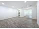 Spacious living area featuring gray wood floors and white walls, showcasing an open floor plan at 4716 Town N Country Blvd, Tampa, FL 33615