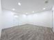 Spacious room with recessed lighting, gray flooring, and a white door at 4716 Town N Country Blvd, Tampa, FL 33615