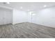 Large, bright room with two entry doors and modern gray floors throughout at 4716 Town N Country Blvd, Tampa, FL 33615