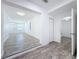 Open-concept living area with gray wood floors, leading into a doorway with an adjacent closet at 4716 Town N Country Blvd, Tampa, FL 33615