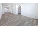 Bright living room featuring neutral walls and stylish gray wood-look flooring at 4716 Town N Country Blvd, Tampa, FL 33615
