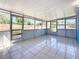 Enclosed sunroom featuring tile floors and large windows, perfect for year-round enjoyment at 4716 Town N Country Blvd, Tampa, FL 33615