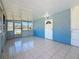 Bright sunroom with tile floors, screened windows and a white front door at 4716 Town N Country Blvd, Tampa, FL 33615