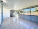 Bright sunroom with tile floors and screened windows at 4716 Town N Country Blvd, Tampa, FL 33615