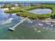 Scenic aerial view of waterfront property, pier, and lush landscaping, offering picturesque views and tranquility at 4801 Osprey S Dr # 404, St Petersburg, FL 33711