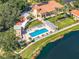 Aerial view of clubhouse, pool, and lake, with a manicured green space creating a serene and luxurious atmosphere at 4801 Osprey S Dr # 404, St Petersburg, FL 33711