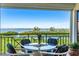 A serene outdoor balcony with comfortable seating and a gorgeous view of the water at 4801 Osprey S Dr # 404, St Petersburg, FL 33711