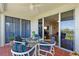 Balcony view with a seating area and glimpse inside showcasing the living room and waterway views at 4801 Osprey S Dr # 404, St Petersburg, FL 33711
