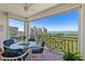 Inviting condo balcony with views of the water and tropical landscape, seating for four and ceiling fan at 4801 Osprey S Dr # 404, St Petersburg, FL 33711